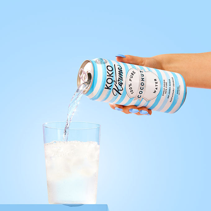 Pouring coconut water in glass